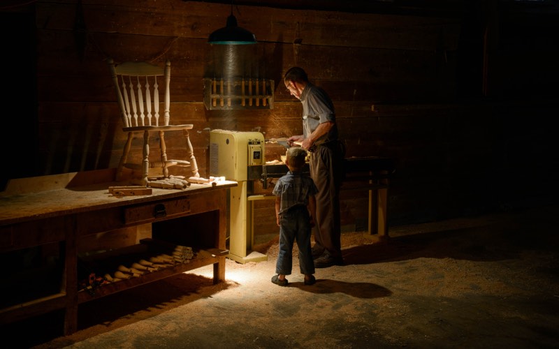 A father and son in a traditional carpentry workshop.